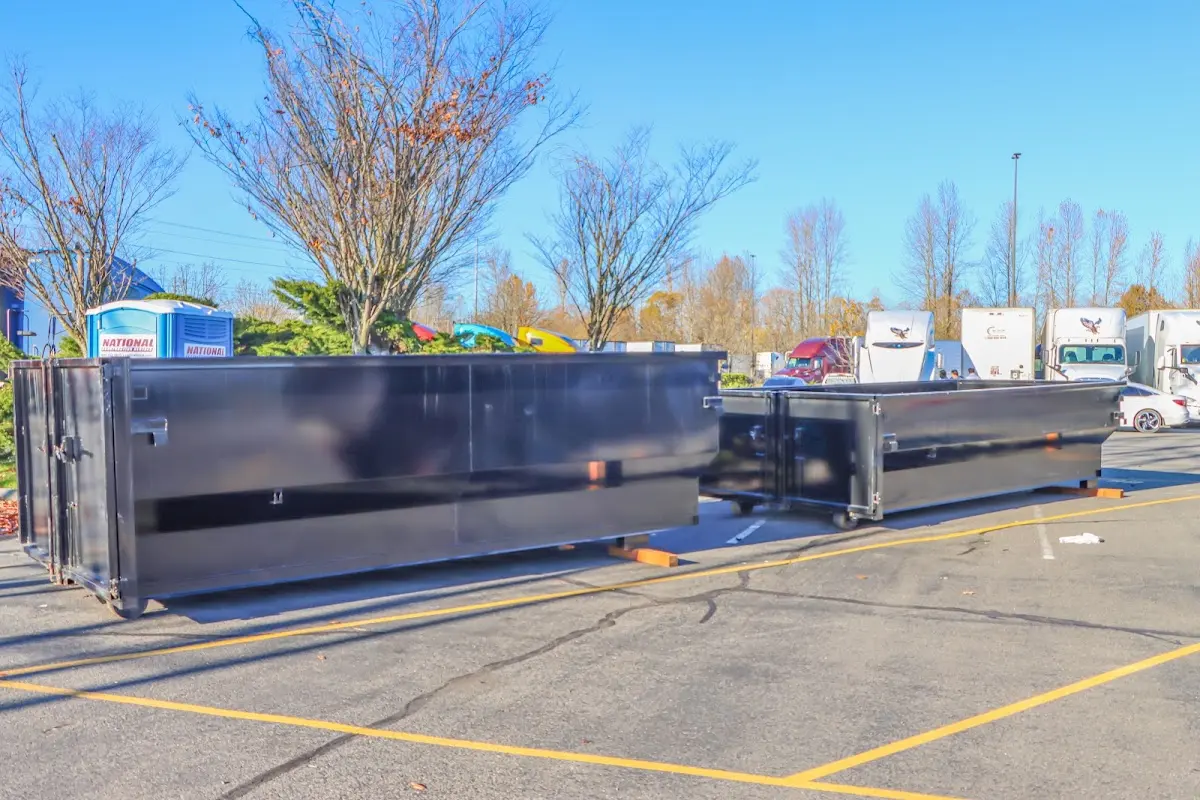 Professional dumpster rental service with roll-off container on residential driveway in Gilroy